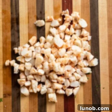 Close-up of perfectly chopped cooked shrimp, ready to be mixed into the salad.