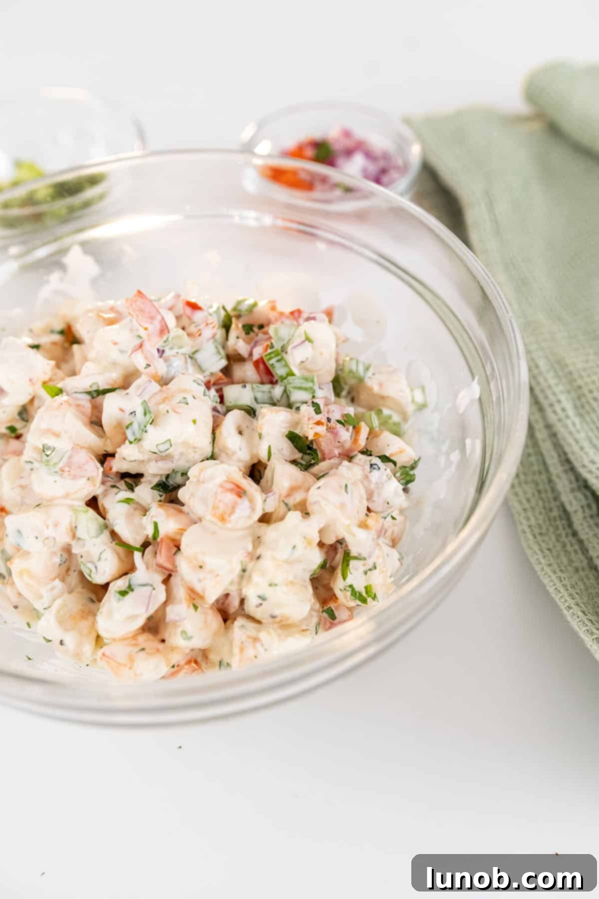 A beautifully presented bowl of cold shrimp salad, ready to be enjoyed.