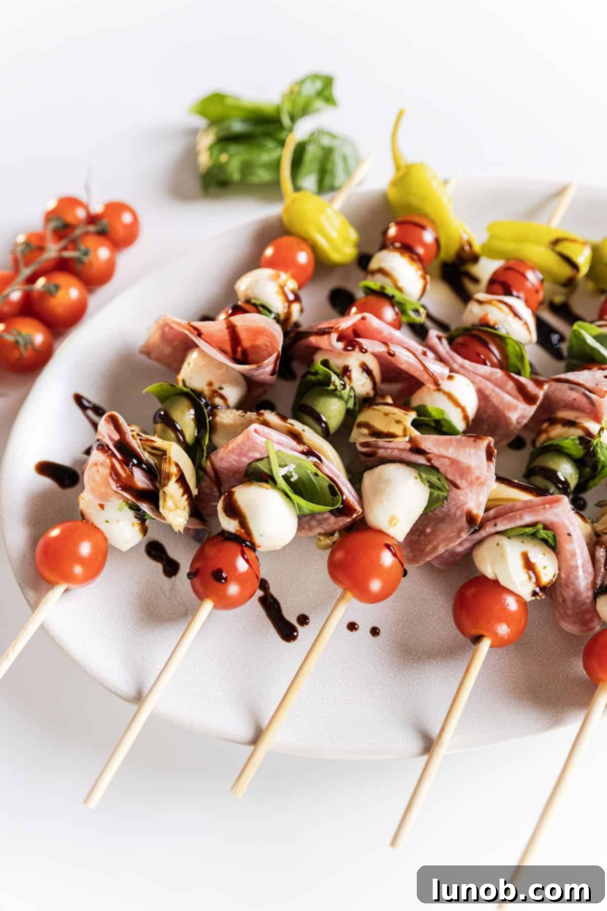 Caprese skewers on a plate, beautifully arranged.