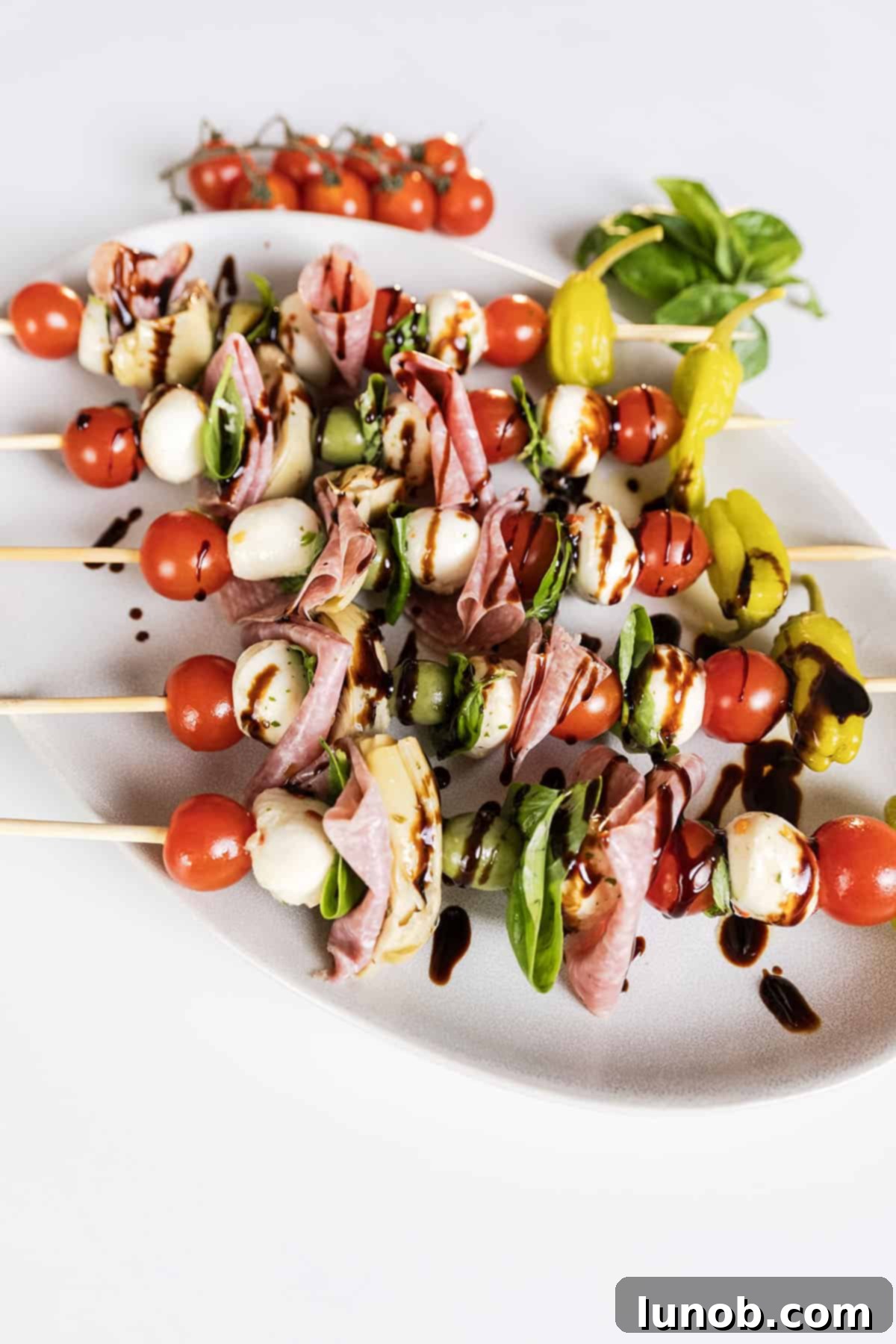 A platter of Caprese antipasto skewers, ready to be served.