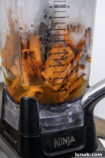 Sweet and Zesty Roasted Carrot Ginger Soup 5 Roasted carrots in blender with broth