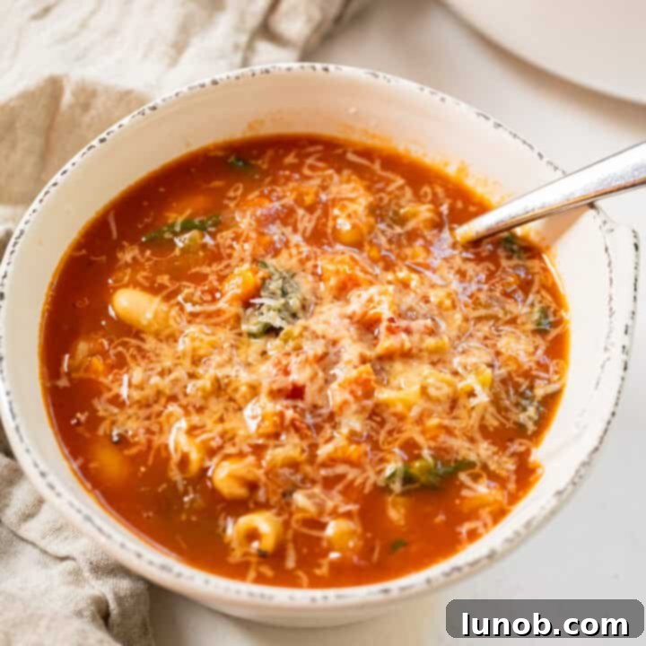 Classic homemade Pasta Fagioli soup, garnished with Parmesan cheese.
