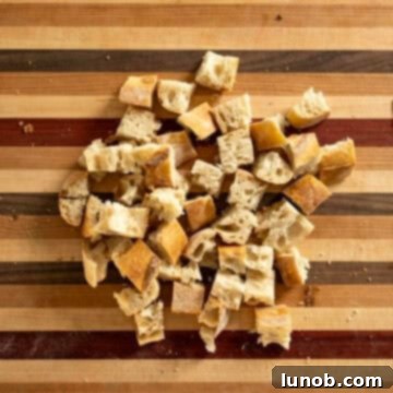 Cubed day-old bread, cut into even, bite-sized pieces, ready for drying.