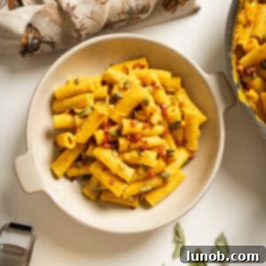 Velvety Pumpkin Pasta 13 Pumpkin pasta in a bowl topped with pumpkin seeds and pancetta.