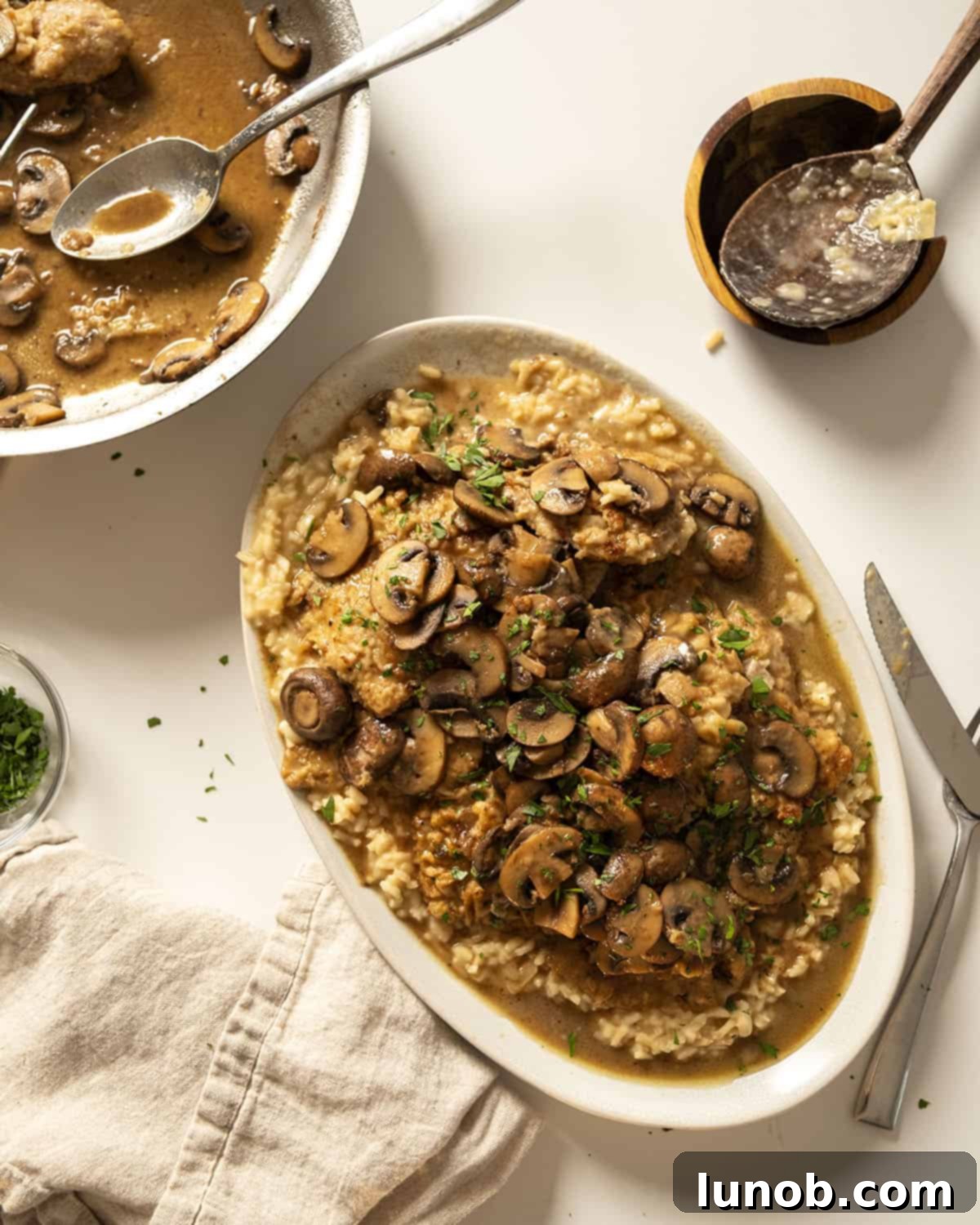 Classic Veal Marsala 2 Veal marsala topped with mushrooms over risotto.