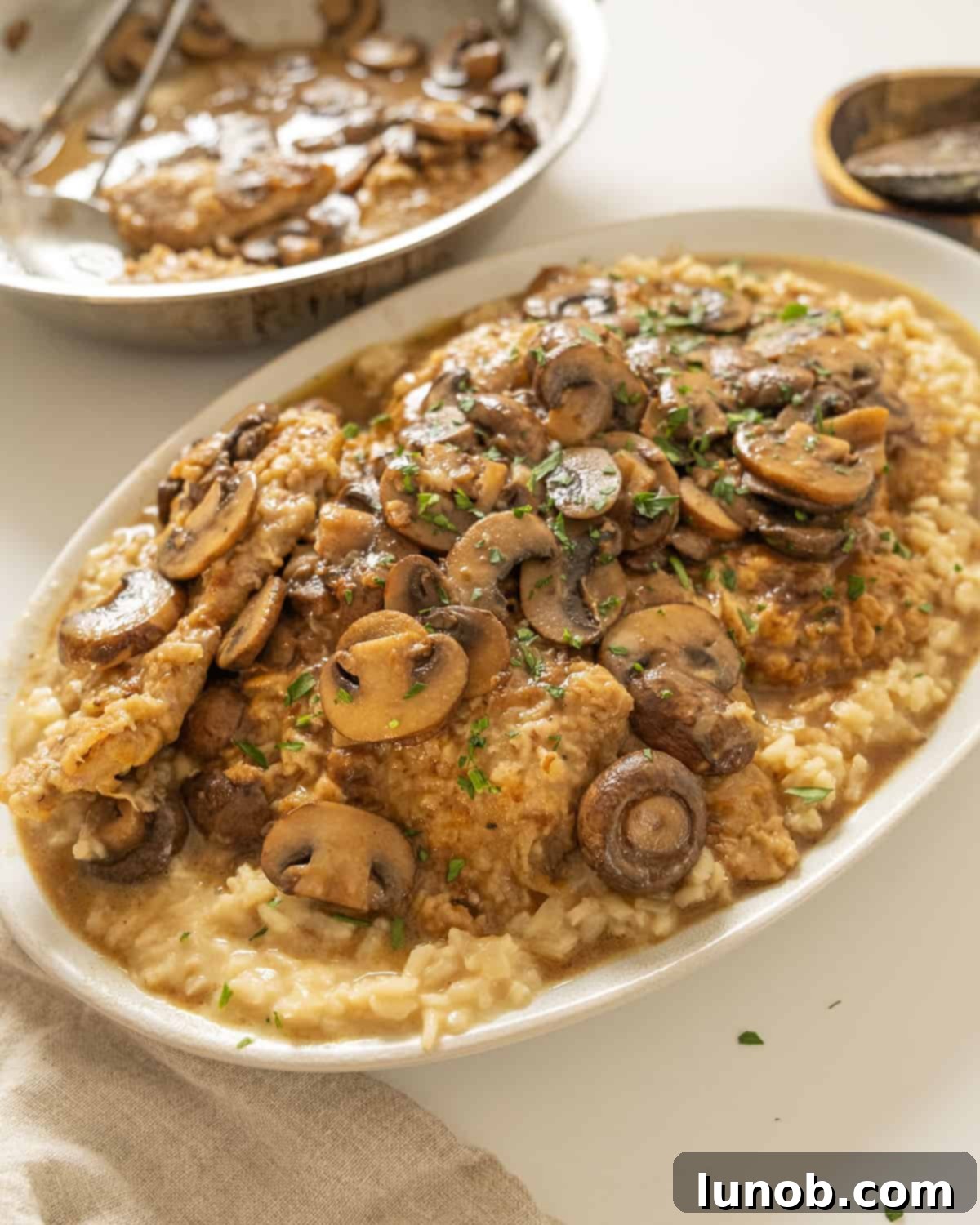 Classic Veal Marsala 11 Veal marsala topped with mushrooms over risotto.
