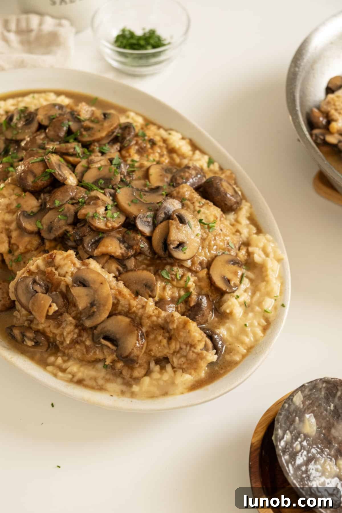 Classic Veal Marsala 12 Veal marsala topped with mushrooms over risotto.