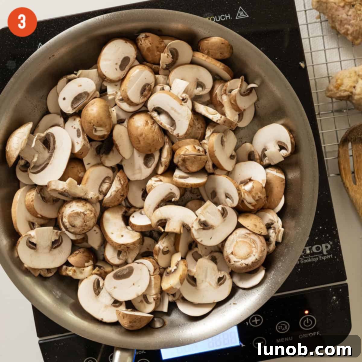 Classic Veal Marsala 6 Sauteing mushrooms in a pan.