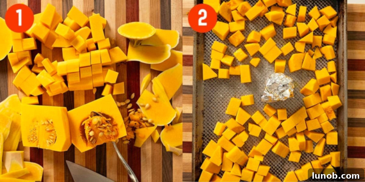 Butternut squash being peeled and chopped into cubes, ready for roasting, with a head of garlic on a baking sheet.