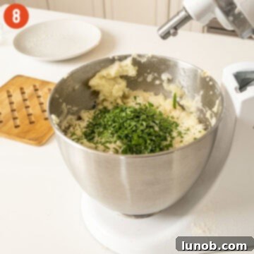 Freshly chopped parsley being folded into the finished mashed potatoes.