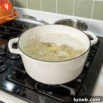 Potatoes boiling vigorously in salted water.