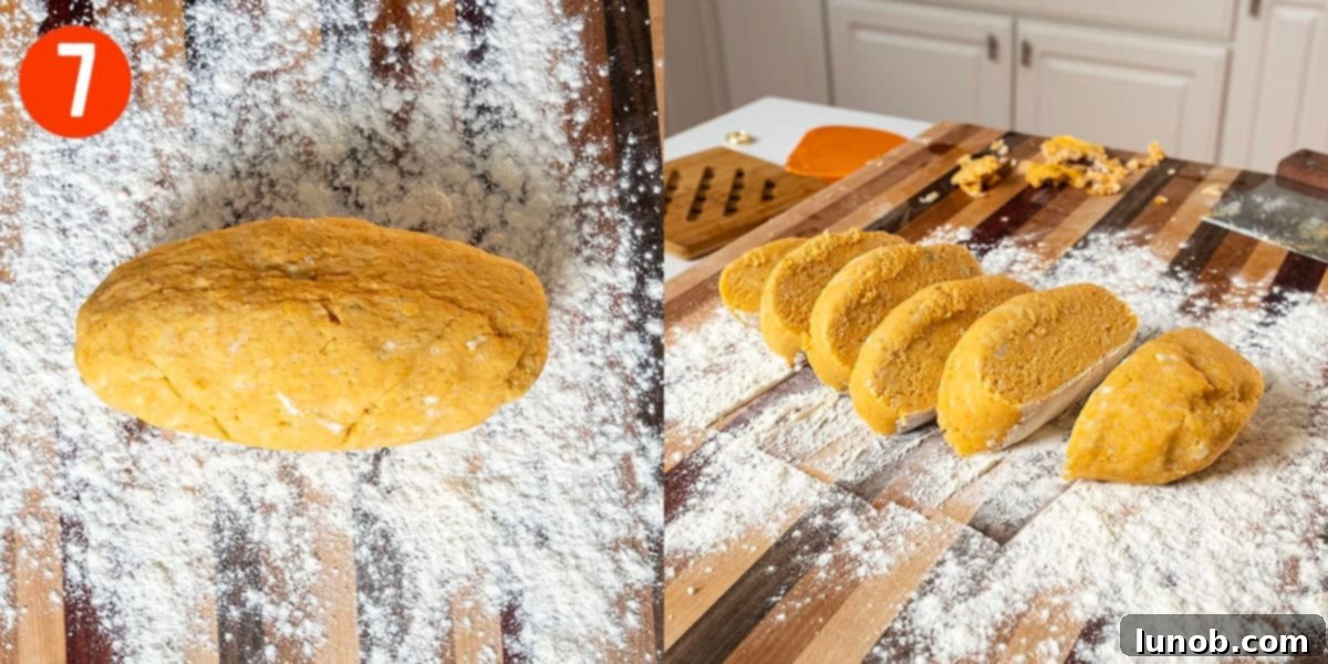 Gnocchi dough rolled into a long log and then being chopped into individual gnocchi disks with a bench scraper.