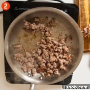 Pumpkin Gnocchi Perfection 5 Browned sausage in a saucepan, ready to be removed.