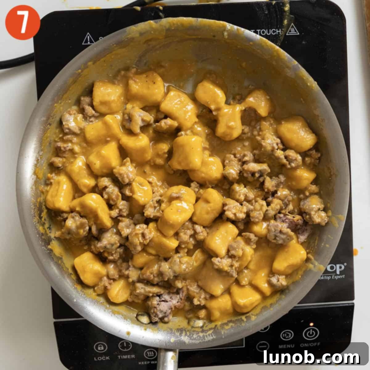 Pumpkin Gnocchi Perfection 10 Cooked sausage being returned to the pumpkin gnocchi pasta.