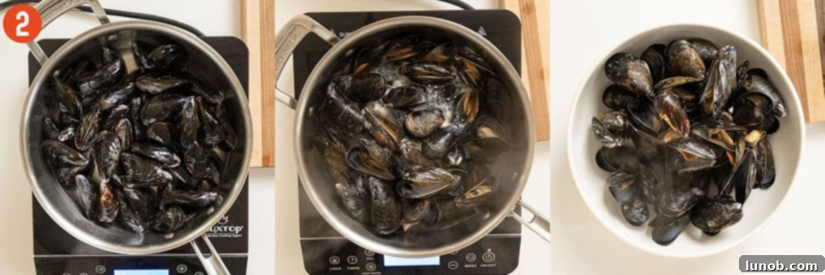 Fresh mussels steaming in a large pan with a lid, shells beginning to open, ready for the seafood salad.